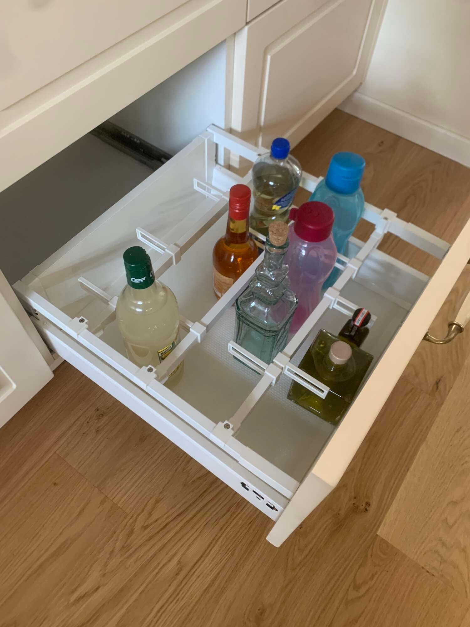 Tiroir coulissant de rangement pour bouteilles dans une cuisine sur mesure à Vitré